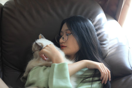 young teen age stay at home and hug a catの写真素材