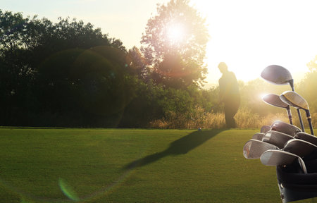 Golf clubs drivers over beautiful golf course at the sunset, sunrise time. , morning timeの写真素材
