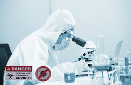 Laboratory research. Team work Scientists  study data and evaluating microscope success. they are doing research with dropper chemical testing life science and find vaccine for covid 19の写真素材