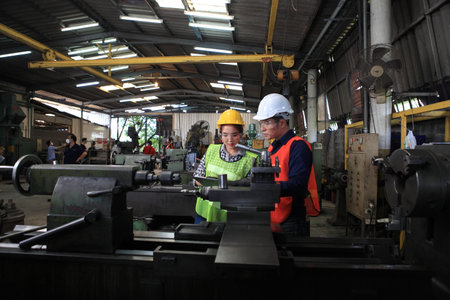 Male and Female Industrial Engineers with  machine. Assist production engineer in industry. He checking or push metalwork control in industrial In a plastic factory for car. Concept Successful of Work.の写真素材