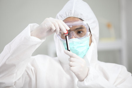 Laboratory research. Team work Scientists  study data and evaluating microscope success. they are doing research with dropper chemical testing life science and find vaccine for covid 19の写真素材
