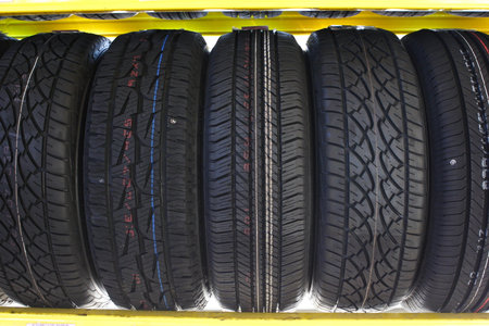 tires of car or vehicle standing in shopの写真素材