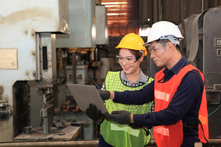 Male and Female Industrial Engineers with  machine. Assist production engineer in industry. He checking or push metalwork control in industrial In a plastic factory for car. Concept Successful of Work.の写真素材