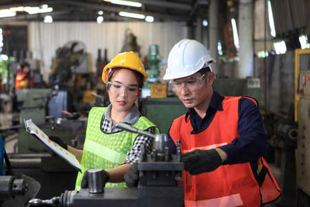 Male and Female Industrial Engineers with  machine. Assist production engineer in industry. ...