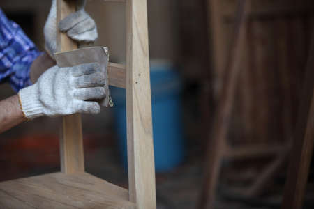 Carpenter, joiner is working in the workshop. Man at work on wood.Image of mature carpenter in the workshop,furniture making concept.の写真素材