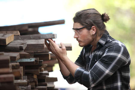 Carpenter, he is working in the workshop. Man at work on wood. Image of mature carpenter in the...