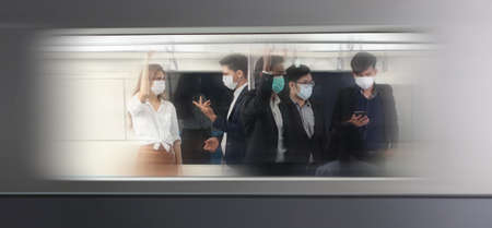 People with masks inside train , People on the train wear anti-virus masks and travel during rush...