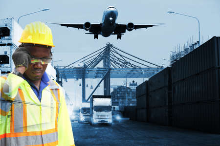 Close up of An African American handsome black engineer he is working in container box yard area,The world logistics  background or transportation Industry or shipping business, Container Cargo  shipment , truck delivery, airplane , import export Conceptの写真素材