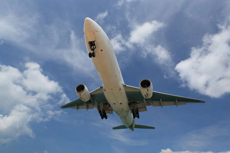 Big white airplane is flying over the clouds with colorful sky at sunset for Business trip with...