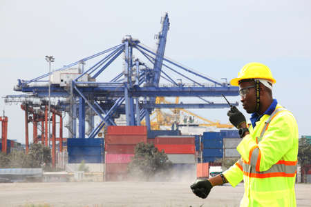 Close up of An African American handsome black engineer he is working in container box yard areaの写真素材