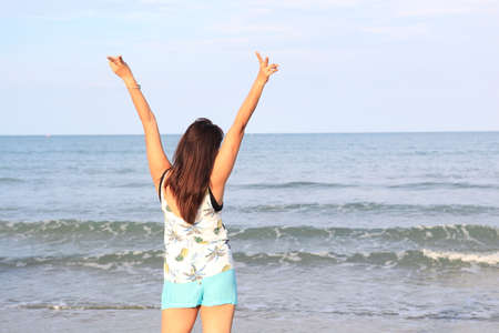 Happy traveler woman in white dress enjoys her tropical beach vacation , Thailand beachの写真素材