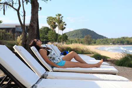 Summer day lifestyle woman relax  at the beach resort outdoors the hotel. Vacations and Summer Conceptの写真素材