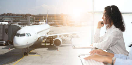 customer support operator against a cloudy sky with airplane, call center service airplaneの写真素材