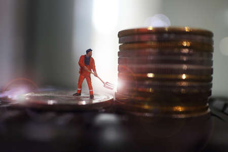 miniature people miner is digging on golden coin. Cryptocurrency bitcoin the future coin, Bitcoin blockchain crypto currency digital encryption, Digital money exchange, Technology global networkの写真素材