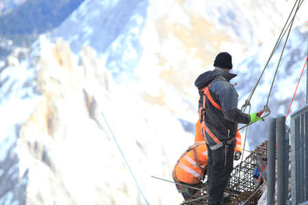 Snow covered mountain peak winter and workerの写真素材