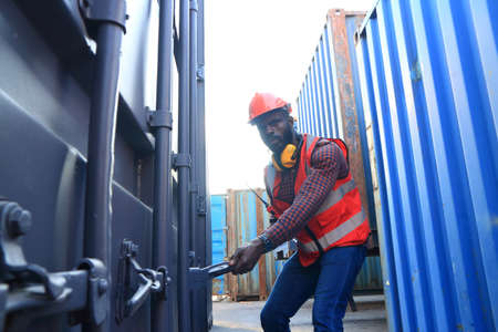 Close up of An African American handsome black engineer he is working in container box yard area of ...