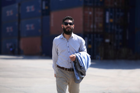 businessman he is working in container box yard area of  logistics transportation import export or shipping industryの写真素材