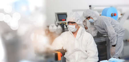 Production engineer or QC   with face mask working in factory , they checking mask production ,...