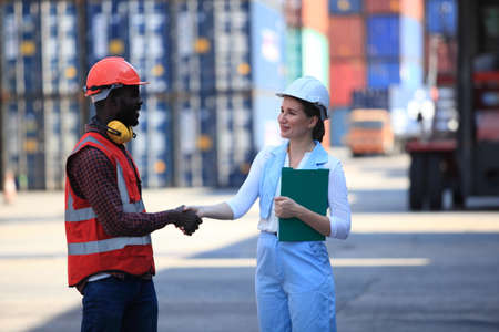 African American  black engineerand businesswoman they are working in container box yard area of  logistics transportation import export or shipping industryの写真素材
