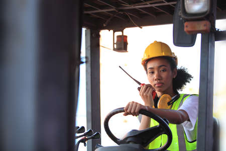 Close up of An African American  black engineer she is working in container box yard area of  logistics transportation import export or shipping industryの写真素材