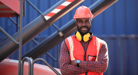 Close up of An African American handsome black engineer he is working in container box yard area of ...