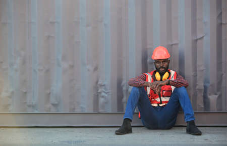 African American handsome black engineer he is working in container box yard area of  logistics transportation import export or shipping industryの写真素材