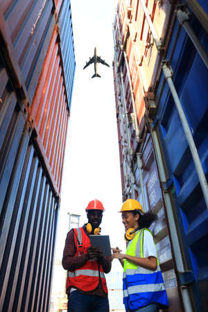 logistics background for delivery business or transportion industry,African American engineer working in container area  logistics transportation import export or shipping industry free-zone areaの写真素材