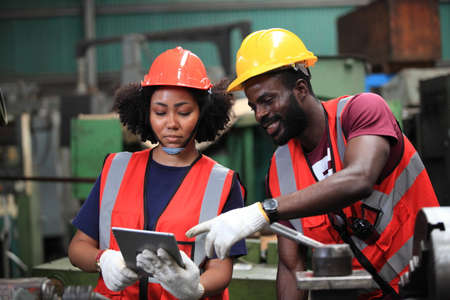 African American engineer skills quality, maintenance, training industry factory worker , warehouse Workshop for factory operators, mechanical engineering team production.の写真素材