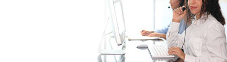 Call center agent with headset working on support hotline in modern office with copy space.