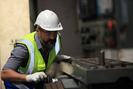 Industrial Engineers with machine.production engineer in industry. He checking or push metalwork...