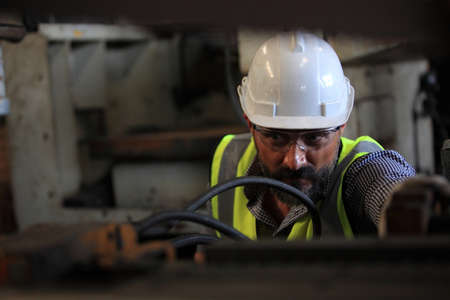 Industrial Engineers with machine.production engineer in industry. He checking or push metalwork...