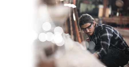 Carpenter working on woodworking machines in carpentry shop. he works in a carpentry shop or warehouseの写真素材