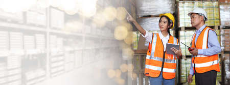 worker in warehouse,  using bar code scanner to scanning box and analyze newly arrived goods.  Working at warehouse.International export business conceptの写真素材
