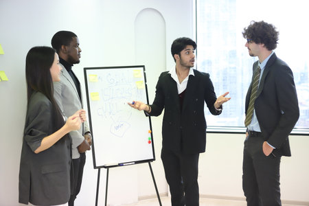 Business coach. Successful business professionals presenting analytical report while working together with colleagues in the modern officeの写真素材