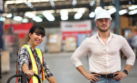 Portrait of worker in warehouse , they  happy and  working at The Warehouse. Storehouse area, Shipment.  warehouse worker unloading pallet goods in warehouseの写真素材