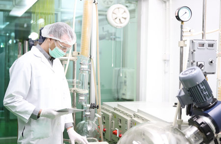scientist analyzing a biological and ecological hemp plant used for herbal pharmaceutical CBD oil and THC oil in a laboratory.の写真素材