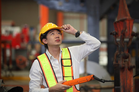 Young Engineer Working with big machineの写真素材
