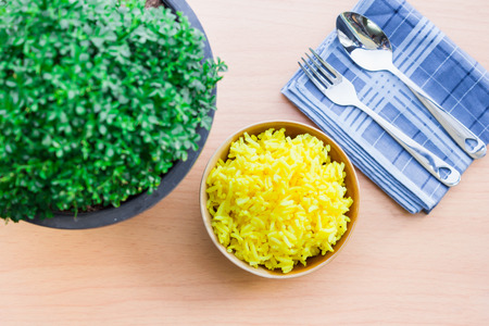Yellow rice, hot to eat on the table is beautiful.の写真素材