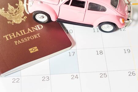Passport of Thailand and small vehicles put on the calendar to show the concepts. The trip is...