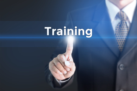A Businessman holding a white sign with the message training. Can bring to the medium of your ad.の写真素材