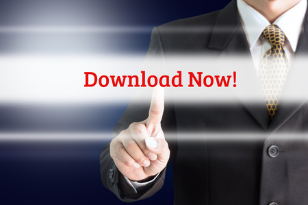 businessman in black suit pushing flat touchscreen button download nowの写真素材