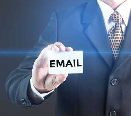 A Businessman holding a white sign with the message Email. Can bring to the medium of your ad.の写真素材
