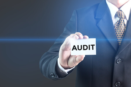 businessman pressing audit button on virtual screens. business conceptの写真素材