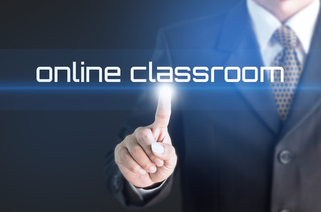 A Businessman holding a white sign with the message online classroom. Can bring to the medium of your ad.の写真素材