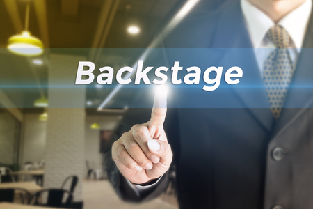 A Businessman holding a white sign with the message Backstage. Can bring to the medium of your ad.の写真素材