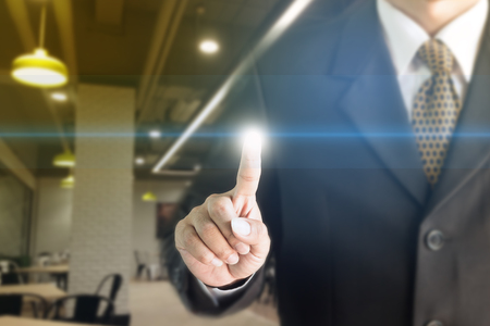 Businessman standing hand touch screen. You can add text to your ad.の写真素材