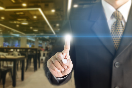 Businessman standing hand touch screen. You can add text to your ad.の写真素材