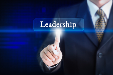 Businessman holding a white sign with the message leadership. Can be used for your advertising.の写真素材