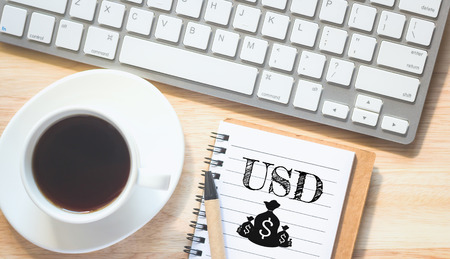 Concept USD (or currency dollars). message on book. A pencil and a glass coffee table.Vintage tone.の写真素材