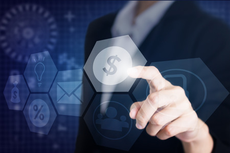 Businessman's hand touching the screen the symbol financial. Can be used for advertising.の写真素材